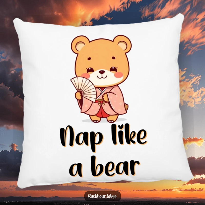 Funny playful bear character in a formal kimono smiles while holding a delicate fan, displayed on a soft decorative pillow.