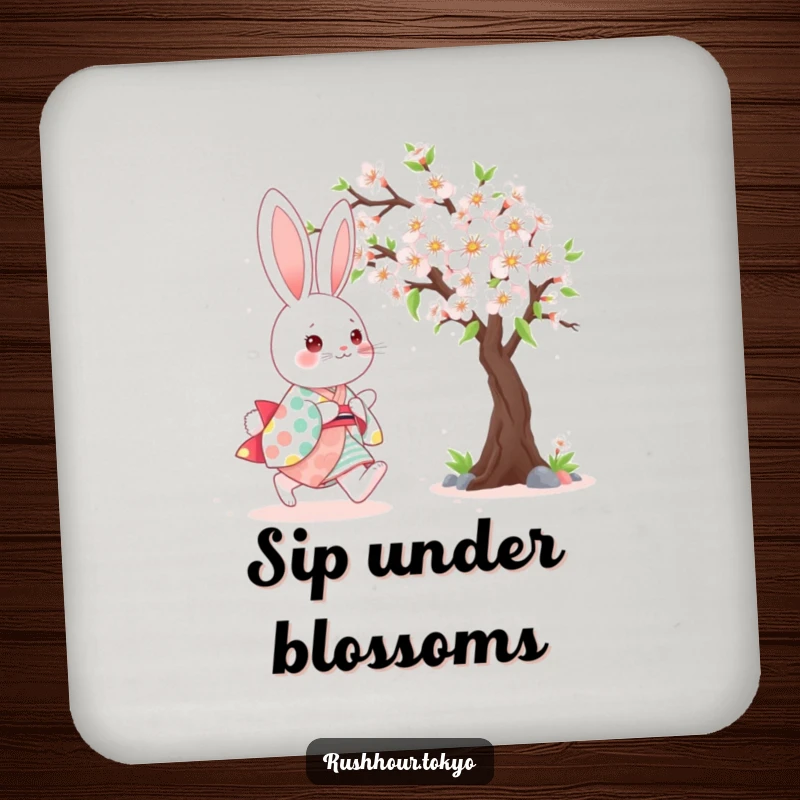 Cute kawaii bunny wearing a colorful kimono, happily skipping beside a blooming cherry tree on a humorous drink coaster.