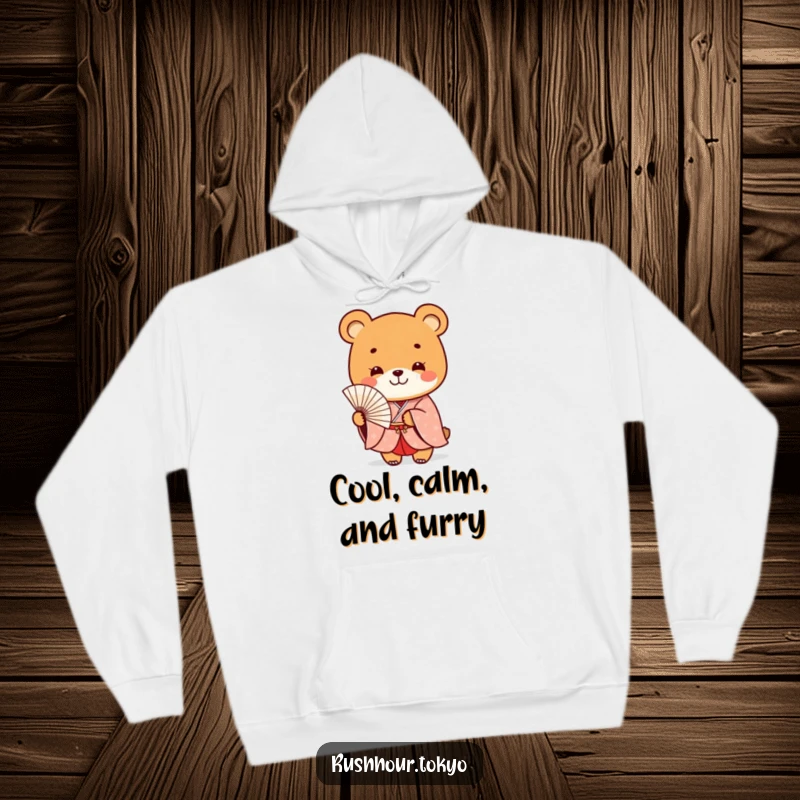 Funny playful bear character in a formal kimono smiles while holding a delicate fan, featured on a warm and cozy hoodie.