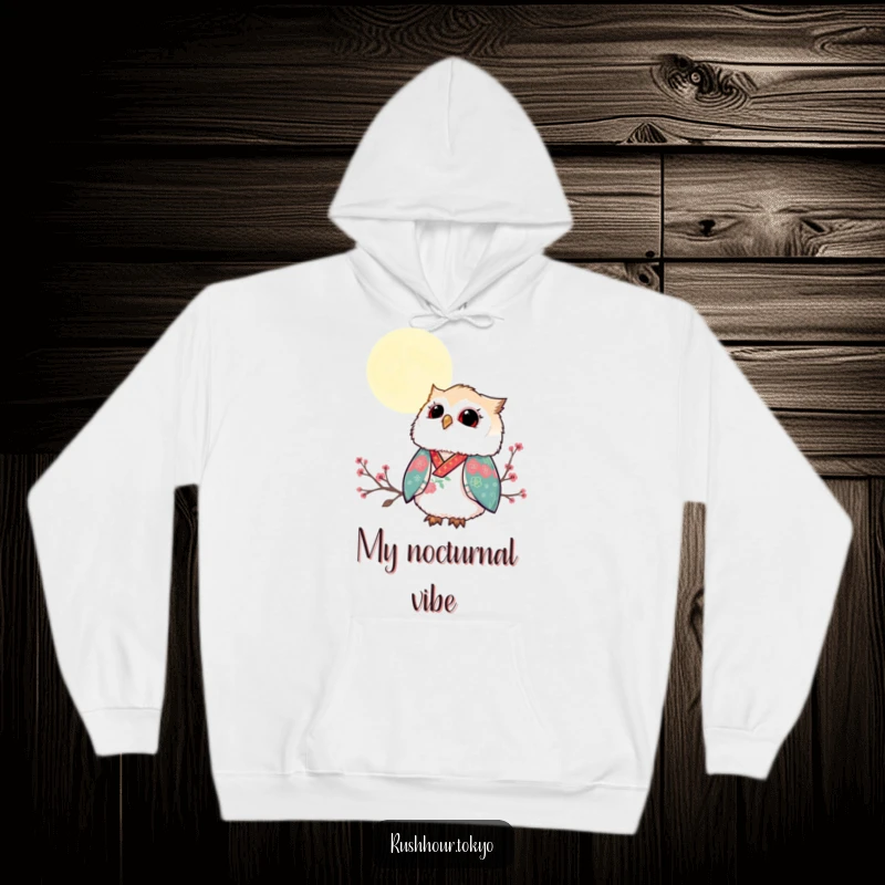 Funny fluffy owl in a vibrant kimono gazing up at a serene moonlit sky, featured on a warm and cozy hoodie.