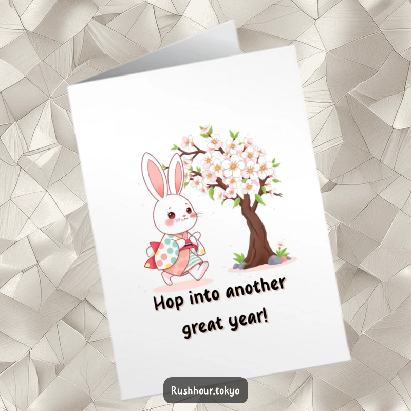 Funny Free Printable Birthday Card: Cute bunny in a colourful kimono happily skipping near a blooming cherry blossom tree.