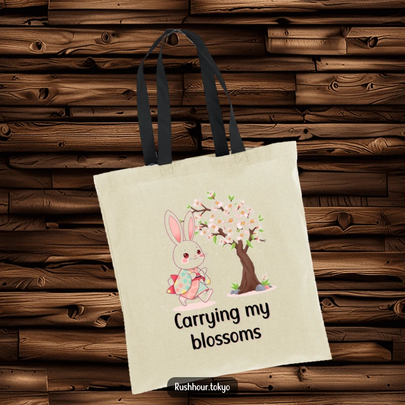 Cute kawaii bunny wearing a colorful kimono, happily skipping beside a blooming cherry tree on a humorous tote bag.
